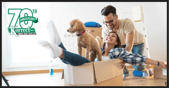 Couple with dog and moving boxes