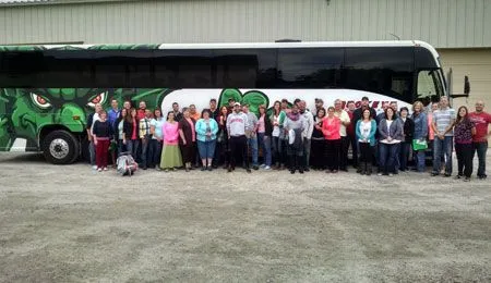 our staff standing in front of a bus