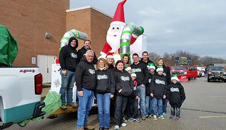 Our staff standing in front of inflatable santa