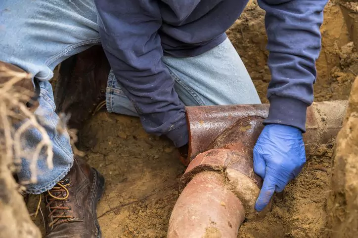 man performing maintenance on sewer lines