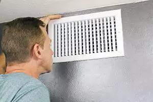 Person looking inside of a vent