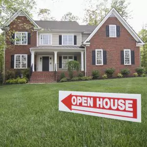 House with an open house sign outside on it's lawn