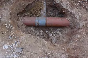 A sewer line revealed in the dirt