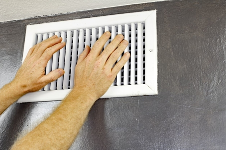 Man adjusting air vents