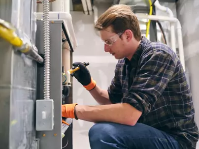 HVAC technician inspecting malfunctioning furnace