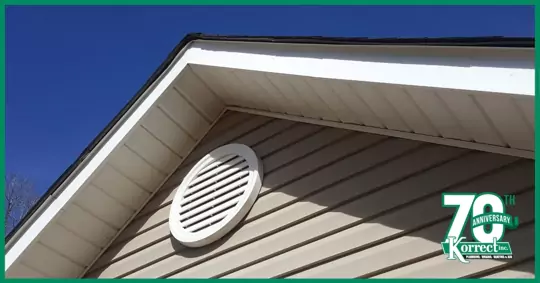 A roof of a home pointed with a ventilation vent on the siding