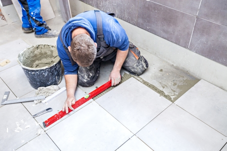 Man tiling bathroom